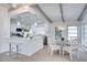 Modern kitchen features white cabinetry, a spacious island, and stainless steel appliances at 1506 Winding W Way, Clearwater, FL 33764