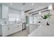 Charming white kitchen boasting stainless steel appliances and bright natural light at 1506 Winding W Way, Clearwater, FL 33764