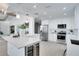 Modern kitchen boasts stainless steel appliances, an island, and open layout to living space at 1506 Winding W Way, Clearwater, FL 33764