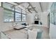 Bright living room featuring vaulted ceilings, a cozy fireplace, large windows, and stylish furnishings at 1506 Winding W Way, Clearwater, FL 33764