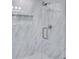 An updated glass shower with bright tile, built in shelves, and modern shower fixture at 1506 Winding W Way, Clearwater, FL 33764