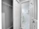 Walk-in closet with wire shelving that opens to an en suite bathroom with marble floors and a shower at 1506 Winding W Way, Clearwater, FL 33764
