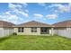 Expansive backyard with lush green grass and a white privacy fence at 15406 Gopher Trop Pl, Sun City Center, FL 33573