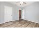 This bedroom has wood-look flooring, two closets and a ceiling fan at 15406 Gopher Trop Pl, Sun City Center, FL 33573