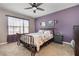 Comfortable bedroom features a ceiling fan, a window and complementary décor at 15406 Gopher Trop Pl, Sun City Center, FL 33573