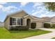 Inviting single-story home featuring a two-car garage and well-maintained landscaping at 15406 Gopher Trop Pl, Sun City Center, FL 33573