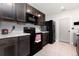 Updated kitchen featuring dark wood cabinets, modern appliances, and bright countertops at 15406 Gopher Trop Pl, Sun City Center, FL 33573