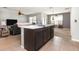 Open-concept kitchen featuring a breakfast bar and black appliances connecting to living area at 15406 Gopher Trop Pl, Sun City Center, FL 33573