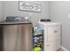 Functional laundry room with modern washer and dryer, plus ample storage at 15406 Gopher Trop Pl, Sun City Center, FL 33573