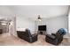 Cozy living room with carpet flooring, ceiling fan, and comfortable leather furniture at 15406 Gopher Trop Pl, Sun City Center, FL 33573