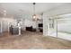 Spacious open-concept living area connecting the kitchen, living room, and sliding door to the patio at 15406 Gopher Trop Pl, Sun City Center, FL 33573