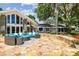 Wide angle shot of the home's large backyard and patio with outdoor seating at 16205 Sentry Woods Ct, Odessa, FL 33556