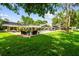 Beautiful backyard with pool, patio, lush landscaping, and comfortable lounge seating at 16205 Sentry Woods Ct, Odessa, FL 33556