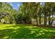 Tranquil backyard with lush landscaping and waterfront views at 16205 Sentry Woods Ct, Odessa, FL 33556