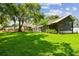 Expansive backyard featuring lush green lawn and mature trees for privacy at 16205 Sentry Woods Ct, Odessa, FL 33556