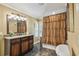 Bathroom features include tile flooring, granite countertops, and tiled tub at 16205 Sentry Woods Ct, Odessa, FL 33556