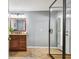 Bathroom featuring a glass shower, a dark wood vanity, and modern fixtures at 16205 Sentry Woods Ct, Odessa, FL 33556