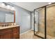 A bathroom featuring tile flooring, a glass enclosed shower, and granite countertops at 16205 Sentry Woods Ct, Odessa, FL 33556