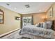 Comfortable bedroom with hardwood floors and sliding glass door offering a water view at 16205 Sentry Woods Ct, Odessa, FL 33556