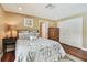 Well-lit bedroom with hardwood floors and spacious closet at 16205 Sentry Woods Ct, Odessa, FL 33556