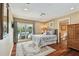 Spacious bedroom with hardwood floors and large windows offering a water view at 16205 Sentry Woods Ct, Odessa, FL 33556