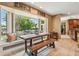 Bright dining area featuring a bay window with backyard views, seamlessly connected to kitchen with tile flooring at 16205 Sentry Woods Ct, Odessa, FL 33556