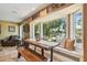 Bright dining area with a large bay window overlooking a scenic backyard with lake view and dock at 16205 Sentry Woods Ct, Odessa, FL 33556