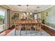 Formal dining room boasts decorative wood furniture, overhead lighting, and neutral wall paint at 16205 Sentry Woods Ct, Odessa, FL 33556