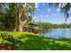 Waterfront views of the private boat dock on the lake with a seating area at 16205 Sentry Woods Ct, Odessa, FL 33556
