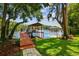 Beautiful lake view with a private covered dock, perfect for relaxing or entertaining near the water at 16205 Sentry Woods Ct, Odessa, FL 33556
