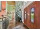 Grand entryway featuring a soaring ceiling, decorative tile flooring, and a unique stone accent wall at 16205 Sentry Woods Ct, Odessa, FL 33556