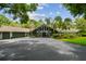 Stunning home exterior featuring a stone facade, mature landscaping, and a spacious driveway at 16205 Sentry Woods Ct, Odessa, FL 33556