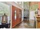 Grand foyer with decorative double doors, beautiful tile floor, and stone accent wall at 16205 Sentry Woods Ct, Odessa, FL 33556