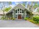 A striking stone exterior and arched windows highlight this home's inviting front entrance at 16205 Sentry Woods Ct, Odessa, FL 33556