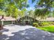 Stunning home featuring mature landscaping and a spacious driveway, providing ample parking for residents and guests alike at 16205 Sentry Woods Ct, Odessa, FL 33556