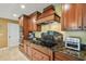 Spacious kitchen featuring granite countertops, custom cabinetry, and stainless steel appliances, perfect for culinary enthusiasts at 16205 Sentry Woods Ct, Odessa, FL 33556