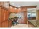 Open kitchen with granite countertops, stainless appliances, and wooden cabinets at 16205 Sentry Woods Ct, Odessa, FL 33556