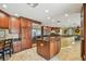 Spacious kitchen features stainless appliances, granite countertops, and wood cabinetry at 16205 Sentry Woods Ct, Odessa, FL 33556