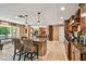 Gourmet kitchen featuring dual islands with granite countertops, custom cabinetry, and open floor plan to dining and living spaces at 16205 Sentry Woods Ct, Odessa, FL 33556