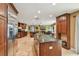 Gourmet kitchen with island, stainless appliances, and wooden cabinetry at 16205 Sentry Woods Ct, Odessa, FL 33556