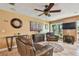 Comfortable living room featuring neutral tones, tile floors, a ceiling fan, and an inviting seating arrangement at 16205 Sentry Woods Ct, Odessa, FL 33556