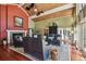 Open concept living room with high ceiling, wood beams, and brick fireplace at 16205 Sentry Woods Ct, Odessa, FL 33556