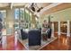 Open living room with vaulted ceiling, ceiling fans, and views of the lake at 16205 Sentry Woods Ct, Odessa, FL 33556