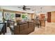 Open-concept living area with seamless flow to dining and kitchen, offering natural light and comfortable seating at 16205 Sentry Woods Ct, Odessa, FL 33556