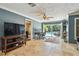Open living room with tile floors offering a view of the outside pool area at 16205 Sentry Woods Ct, Odessa, FL 33556