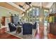 Spacious living room with a soaring ceiling, wood beams, and lake views at 16205 Sentry Woods Ct, Odessa, FL 33556