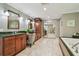 Bathroom with dual sink vanity, granite counter, walk-in closet and bathtub at 16205 Sentry Woods Ct, Odessa, FL 33556