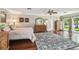 Spacious main bedroom with walk-out to patio, beautiful rug, and ceiling fan at 16205 Sentry Woods Ct, Odessa, FL 33556