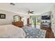 Spacious main bedroom with walk-out to patio, beautiful rug, and ceiling fan at 16205 Sentry Woods Ct, Odessa, FL 33556