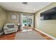 Office with hardwood floors, sliding glass doors to the backyard and a serene view at 16205 Sentry Woods Ct, Odessa, FL 33556